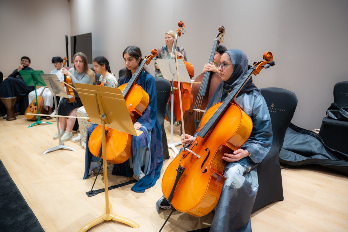 Musicians rehearsing with cellos during the Empowering Emirati Musicians Program