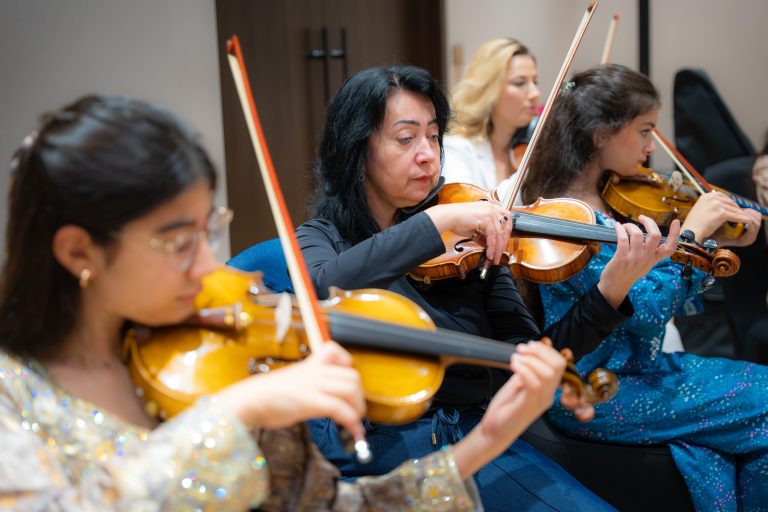 Violinists rehearsing during the Empowering Emirati Musicians Program