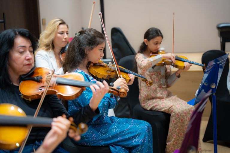 Violin section rehearsing together in the Empowering Emirati Musicians Program
