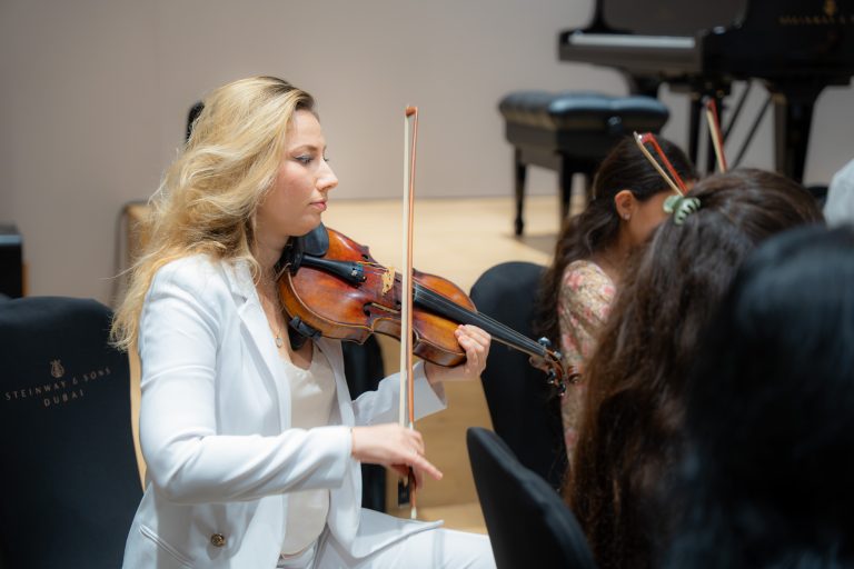 Violinist performing during an Empowering Emirati Musicians Program rehearsal