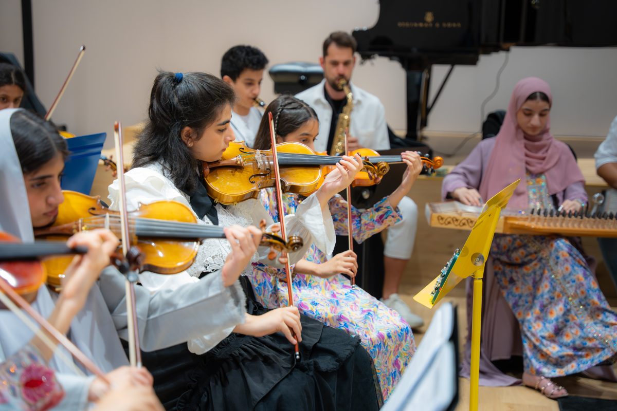 String players and qanun player rehearsing together in the Empowering Emirati Musicians Program