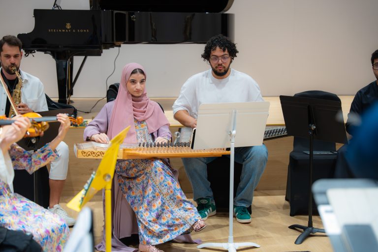 Qanun players and saxophonist during an Empowering Emirati Musicians Program rehearsal