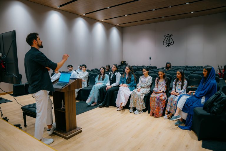 Presenter addressing participants during a Music District masterclass