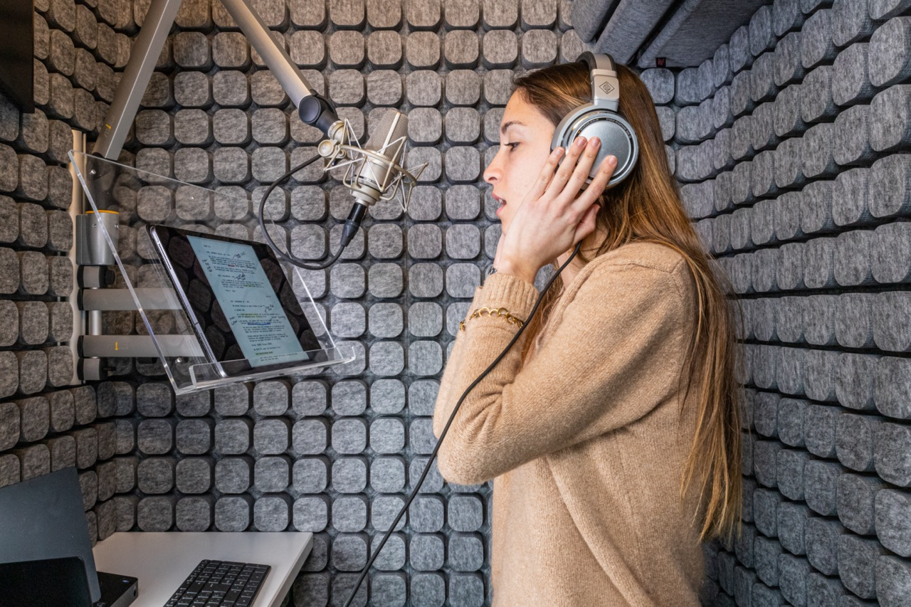 Voice-over performer recording inside a Studiobricks booth